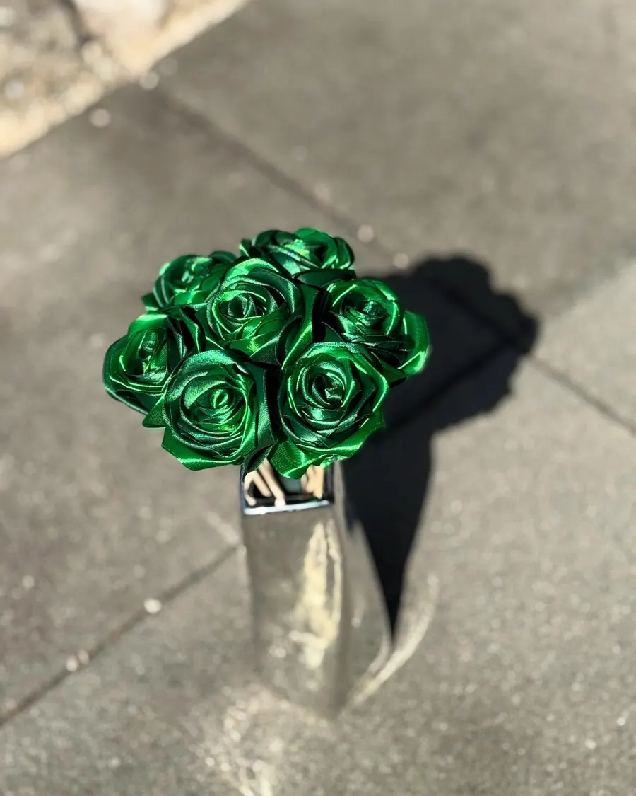 Bouquet de roses en satin vert émeraude dans un vase argenté